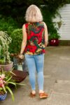 Colorful sleeveless retro design top in red with patterns. 