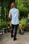 Sleeveless short shirt in summerblue with a small collar and incision at the front