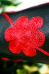 Close up of red floral embroidery on a longshafted high heeled leather boot
