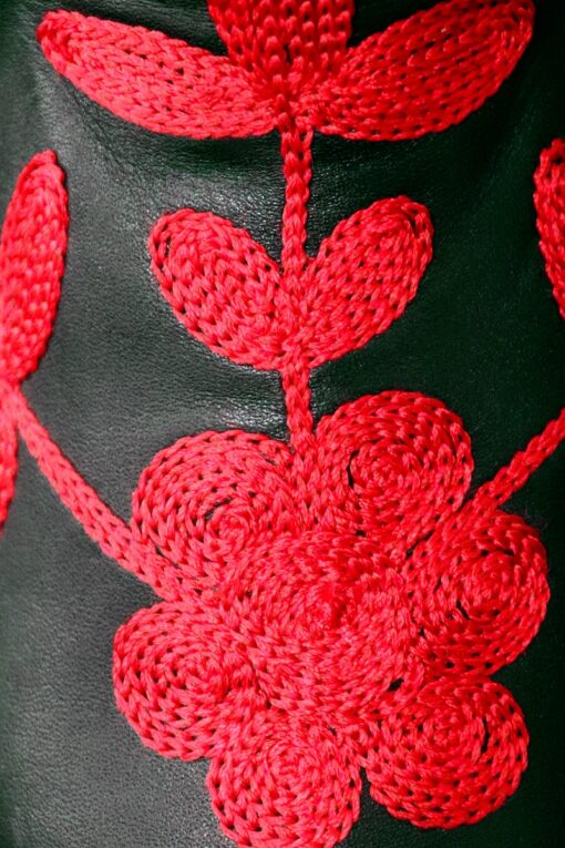 Red embroidery on long-shafted leather boots. handmade