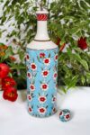 Handmade ceramic oil bottle in turquoise, with red and white floral motifs