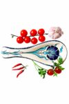 Trendy kitchenware - spoon rest in handmade ceramics decorated with a blue carnation on a white backdrop. For kitchen and serving cutlery