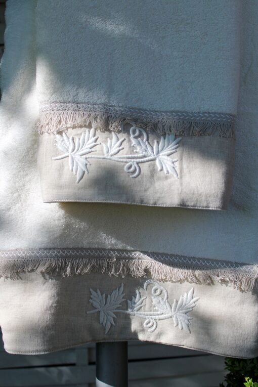Elegant embroidery on a khaki colored border decorating a thick light organic towel set